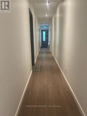 Toronto (Moss Park) condo for rent - A long hallway with a door at the end.
