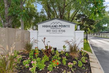 Cottonwood Heights apartment for rent - A sign for Highland Pointe Apartments is surrounded by flowers and greenery.