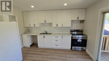 Innisfil (Alcona) house for rent - A kitchen with white cabinets and a sink.