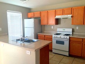 Las Vegas house for rent - a kitchen with a sink stove and refrigerator