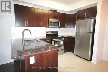 Ottawa condo for rent - A kitchen with a refrigerator, microwave, oven, and sink.