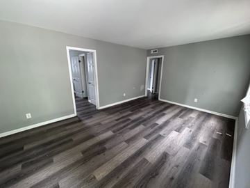 East Point apartment for rent - A room with wood flooring and two doors.
