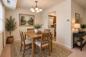 Parkville townhouse for rent - A dining room with a wooden table and chairs.