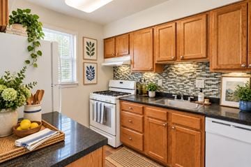 Parkville townhouse for rent - A kitchen with wooden cabinets and a white oven.