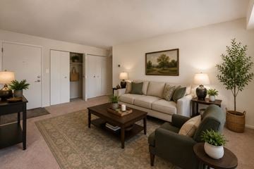 Parkville townhouse for rent - A living room with a couch, chair, and a painting on the wall.