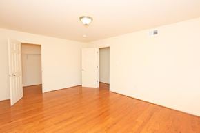Laurel apartment for rent - A room with wooden floors and white walls.