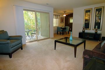 Parkville apartment for rent - A living room with a glass table and a couch.