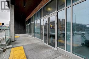 Kitchener condo for rent - A realtor sign is on the wall of a building.