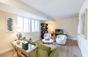 Norwood townhouse for rent - A living room with a green couch and a glass coffee table.