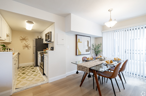 Norwood townhouse for rent - A modern kitchen with a dining table set for two.