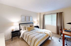 Norwood townhouse for rent - a bedroom with a bed and a desk and a window