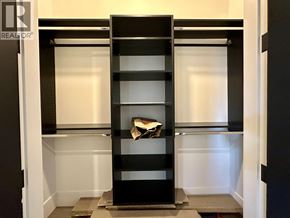 Vancouver house for rent - A black bookshelf with a book on the top shelf.