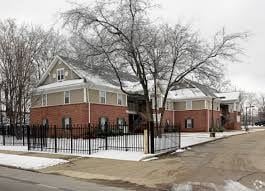 Memphis apartment for rent - A brick house with a black fence in front.