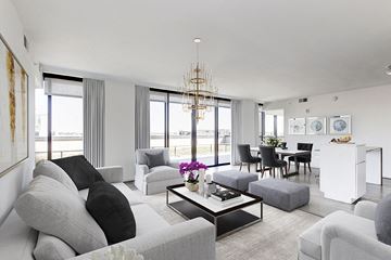 Washington apartment for rent - a white living room with couches and chairs and a table