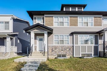 Calgary apartment for rent - A modern house with a grey front and a stone wall.