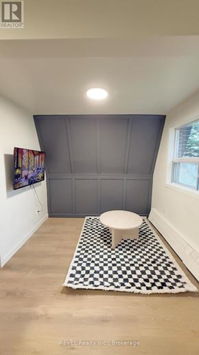 Toronto (Roncesvalles) condo for rent - A bathroom with a toilet and a checkered rug.