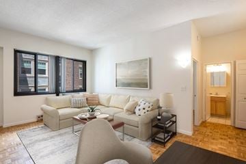 Cambridge apartment for rent - A living room with a couch, chair, and a painting on the wall.