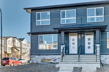 Calgary apartment for rent - A modern two-story house with a grey exterior and white trim.