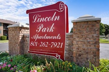 Taylorsville apartment for rent - A sign for Lincoln Park Apartments is displayed in front of a brick wall.