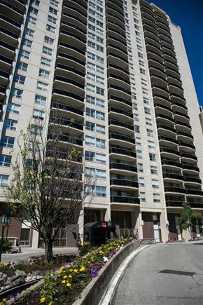 Toronto apartment for rent - A tall residential building with a sidewalk in front of it.