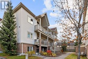Ottawa condo for rent - A multi-story residential building with a balcony on the second floor.