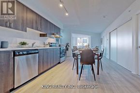 Toronto (West Hill) condo for rent - A modern kitchen with a dining table set for two.