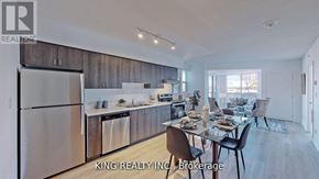 Toronto (West Hill) condo for rent - A modern kitchen with a dining table set for two.