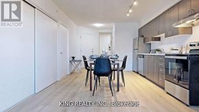 Toronto (West Hill) condo for rent - A modern kitchen with a dining table set up.