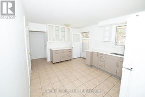 Waterloo duplex for rent - A kitchen with a white door and a window.