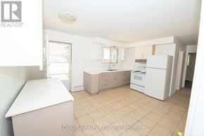 Waterloo duplex for rent - A room with a blue chair and a window overlooking a street.