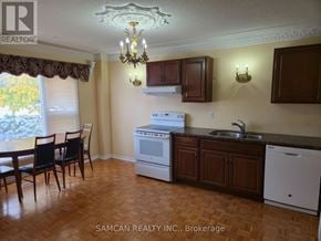 Oakville (Cv Clearview) house for rent - A kitchen with a table and chairs in front of a window.