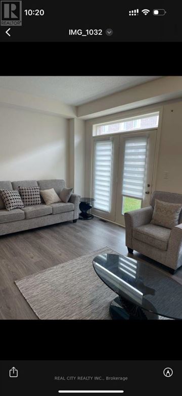 Hamilton (Waterdown) house for rent - A dog is standing in a living room with a couch and a coffee table.
