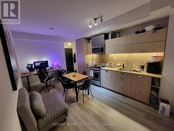 Toronto (Waterfront Communities) condo for rent - A modern kitchen and living room area with a dining table and chairs.