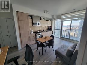 Toronto (Waterfront Communities) condo for rent - A modern kitchen with a dining table and chairs.