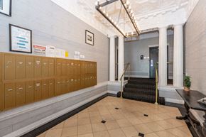 San Francisco apartment for rent - the lobby of a building with lockers and a staircase