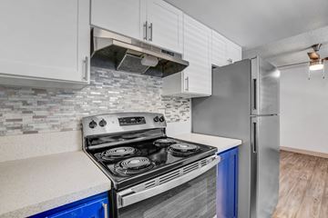 Las Vegas apartment for rent - A modern kitchen with a stove top oven and a refrigerator.