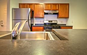 Camden apartment for rent - Kitchen counter top with stainless steel appliances and wooden cabinets