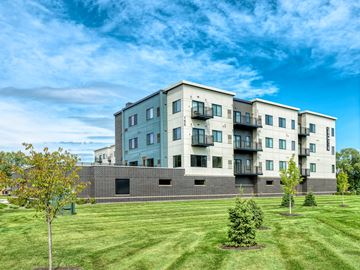 Shoreview apartment for rent - A large apartment building with a grassy area in front.