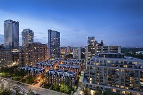 Toronto apartment for rent - A cityscape at dusk with a mix of modern and traditional buildings.