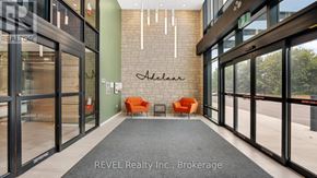 Lincoln (Lincoln-Jordan/Vineland) condo for rent - A hallway with glass doors and a green wall with a sign that says "Aedas".