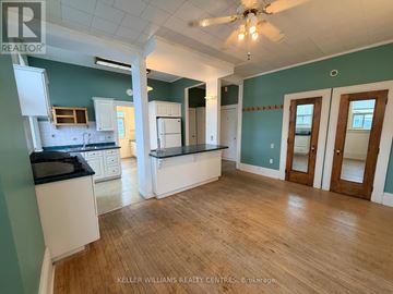 Penetanguishene multi-family for rent - A kitchen with a black counter top and white cabinets.