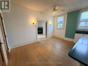 Penetanguishene multi-family for rent - A room with a wooden floor and a ceiling fan.