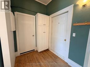 Penetanguishene multi-family for rent - A room with two white doors and a brokerage sign.