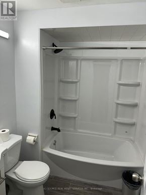 Toronto (Bridle Path-Sunnybrook-York Mills) house for rent - A white bathroom with a toilet, a tub, and a towel rack.