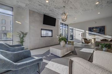 Layton apartment for rent - A modern living room with a grey sofa and a grey carpet.