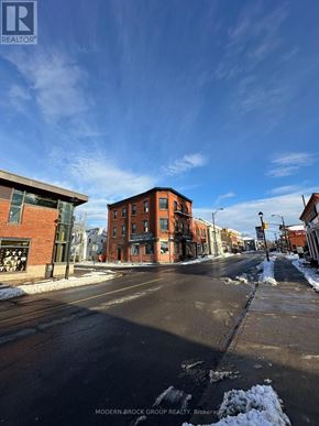 For rent in North Grenville - A street view of a residential area with a sign for Modern-Brock Grove Realty.