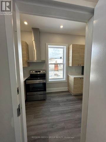For rent in North Grenville - A modern kitchen with a stainless steel oven and a window.