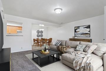 Salt Lake City apartment for rent - A living room with a grey coffee table and a white couch.
