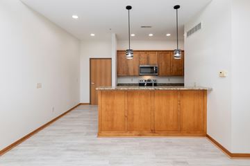 West Des Moines apartment for rent - A kitchen with wooden cabinets and a marble countertop.