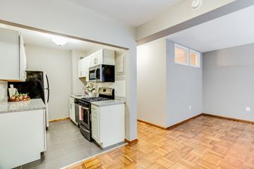 Washington apartment for rent - A kitchen with a refrigerator, oven, and microwave.